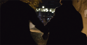 Sherlock and John hold hands while escaping.