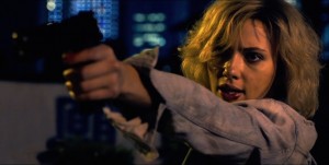 As an action heroine, Lucy wields a gun and kills without hesitation