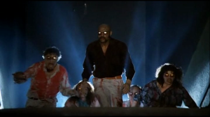 Tony the Pimp (Bobby Rhodes) leads other demon possessed theater patrons after more victims.