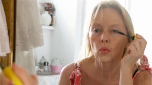 Agneta applies make-up in an attempt to look young